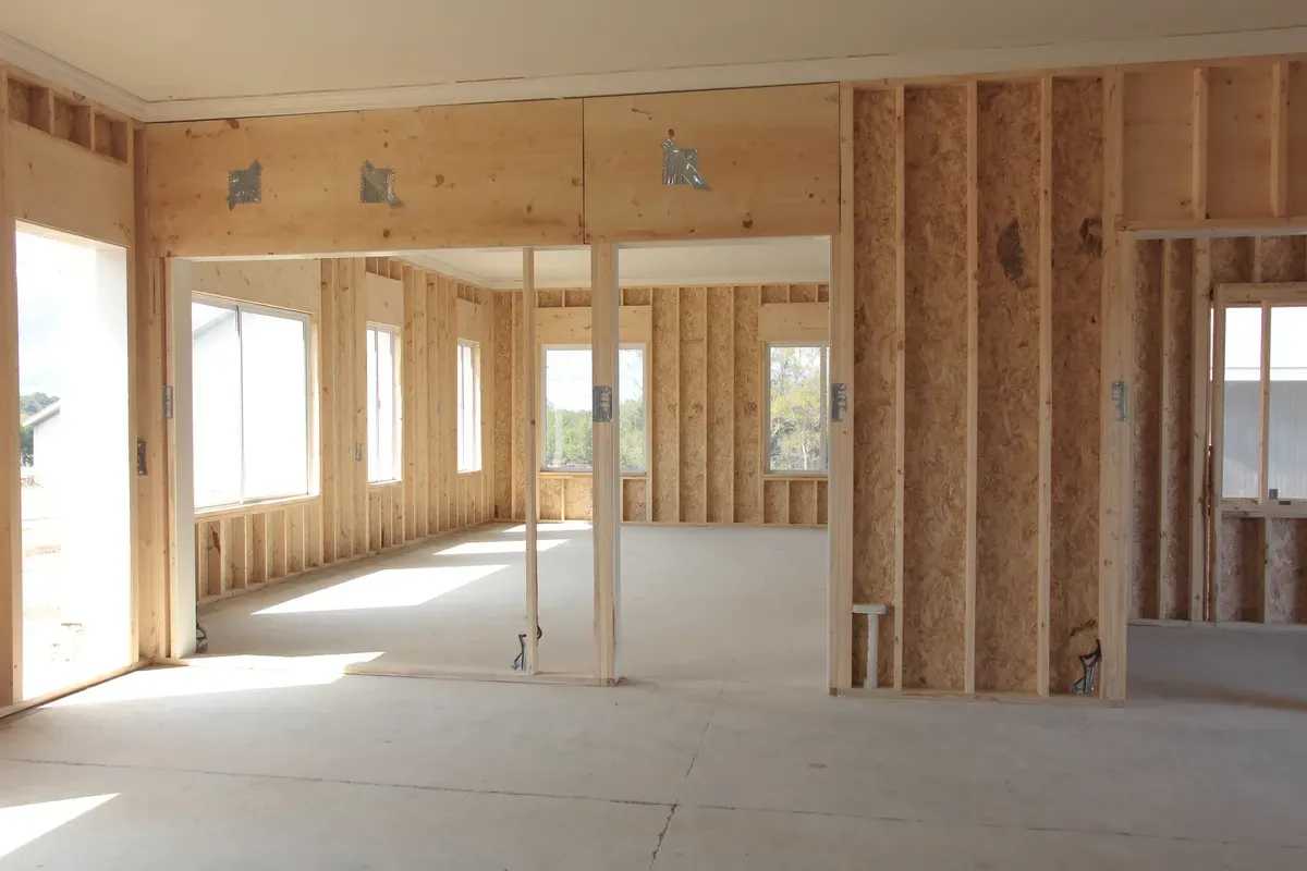 Clean residential framing with hurricane straps inside a post-frame home in Alabama